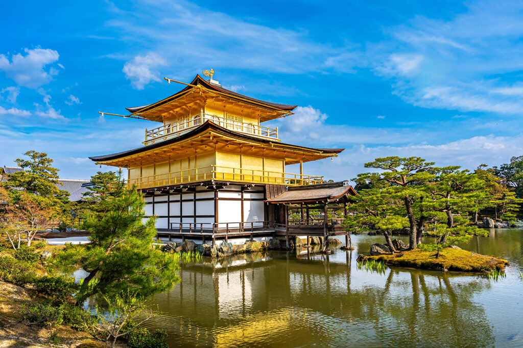 Kinkakuji Temple by the middle of the pond surrounded with Japanese garden